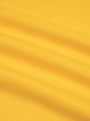 Fabric close up in yellow, flat knit grain of the 83 percent cotton 17 percent polyester blend