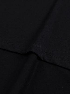 A fold of the black cotton, showing the even 230 gsm knit and its matte washed surface