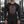 Front view on a man in a gym, the black compression shirt fitted over the chest and arms, with shorts