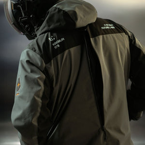 Back view of the grey windbreaker, hood down, long centre-back zip and printed shoulder graphics