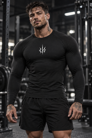 Gym Long Sleeve Compression Shirt on a man in a gym, front view, the shirt tight over chest and arms
