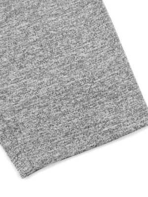 Close-up of the flecking gray hem, the heathered polyester and spandex knit folded at the edge