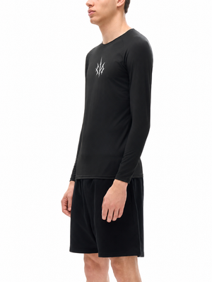 Side view on the model in the black compression shirt, the knit close along the chest and back