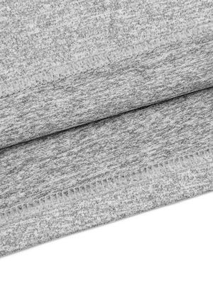 Close-up of the bottom hem stitching on the Flecking Gray gym compression shirt, stretch knit fabric
