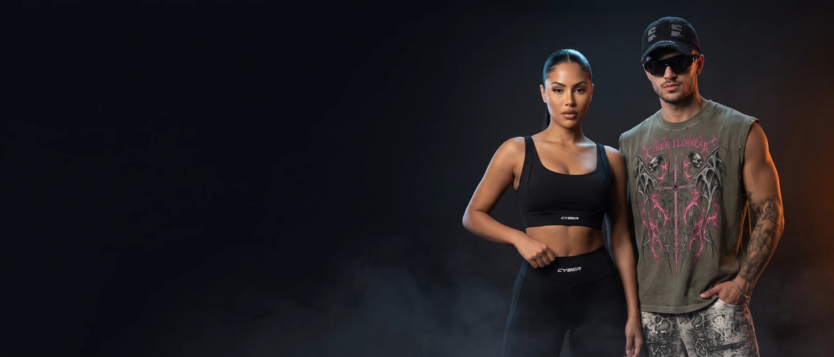Woman in a black Cyber cross-back sports bra and high-waisted leggings beside a man in a distressed goth muscle shirt, black Y2K cap and sunglasses — Ghost Mode new drop by Cyber Techwear