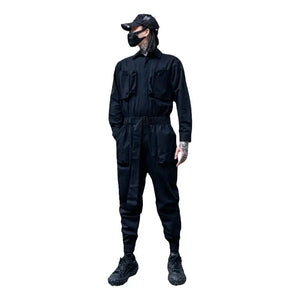 Person wearing a black jumpsuit, cap, and mask on a white background