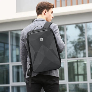 Black hardshell backpack with a moulded front panel and an external USB port
