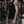 A model wears the black tank in a gym, the cut following the shoulder without pulling
