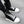 Black White high top boots with white laces, white toe cap and white ridged sole, worn