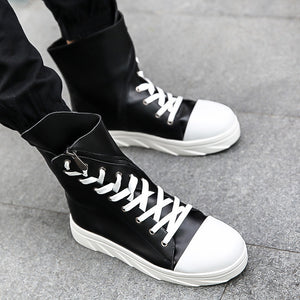 Black White high top boots with white laces, white toe cap and white ridged sole, worn