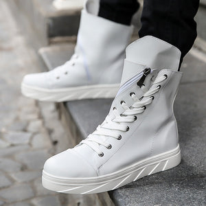 White high top sneaker boots worn on stone steps, zip open at the side and tall collar