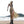 Woman on the shore in the hooded khaki dress, three-quarter view with the mesh skirt blowing in the wind