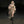 Model walking in the hooded khaki maxi dress with a faux fur coat and tall black boots, dark studio, front view