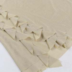 Detail of the ruffled hem on the hooded cut out dress, small pointed khaki mesh frills stitched in rows