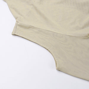 Detail of the sleeveless armhole on the khaki hooded dress, clean finished edge on the fine mesh fabric