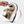 Hand bending a Khaki knit mesh sneaker, showing the flexible textured white sole