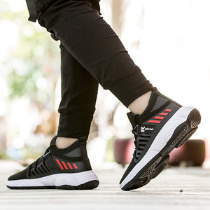 Man walking in Black knit mesh sneakers with red stripes and black joggers, side view