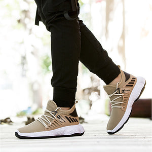 Khaki knit sneakers worn with black joggers, mid-step outdoors, black stripes on the side