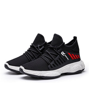 Pair of Black knit mesh techwear sneakers on white, lace loops and bubble-textured sole