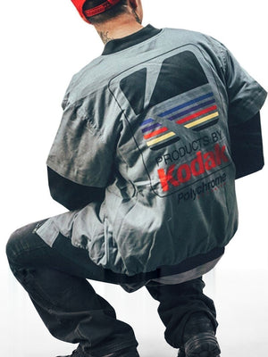 Back of the grey layered sleeve baseball bomber jacket with the large retro print, man seated