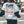 Back of the white layered sleeve baseball bomber jacket with a large retro graphic print and black sleeves