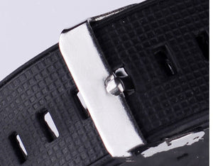 Close-up of the metal strap keeper and adjustment holes on the black rubber strap of the LED speedometer watch