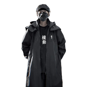 Person wearing a black coat and mask in front of a corrugated metal wall