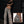 Woman leaning on a dark wall in tree camo cargo pants, with an inset close-up of the back pocket