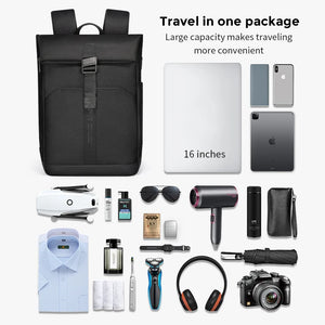 Black roll top backpack closed by a magnetic clasp across the front