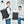 Black roll top backpack closed by a magnetic clasp across the front
