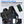 Black roll top backpack closed by a magnetic clasp across the front