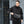 Magnetic Clasp Techwear Sling worn by a man in black, insets of the outer port and inner power bank cable