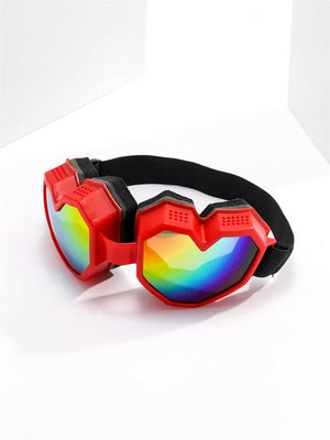 Red goggles with rainbow lenses on a white background