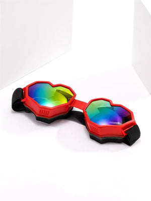 Red and black goggles with colorful lenses on a white background