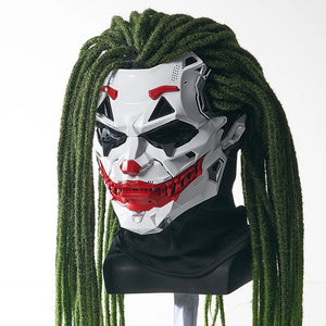 Mask with red and black design on a mannequin head with green hair against a white background