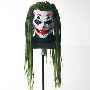 Joker mask with green hair on a mannequin head against a white background