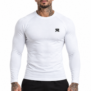 Mens Long Sleeve Compression Shirt in white on a man, front view, a small black logo on the chest