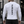 Back view on a man in a gym, black gothic lettering running down the spine of the white shirt