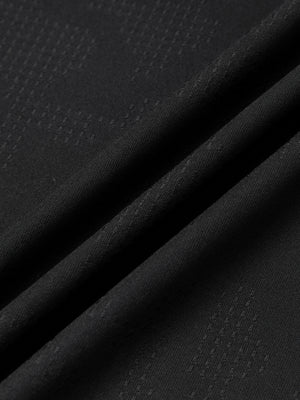 Black jacquard mesh fabric of the gym shirt in soft folds, with its small dotted check pattern