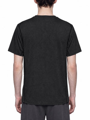 Black slim fit mesh gym shirt seen from the back on a model, topstitched seams over grey shorts