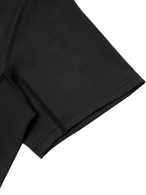 Detail of the black short sleeve hem and the topstitched seam on the jacquard mesh gym shirt