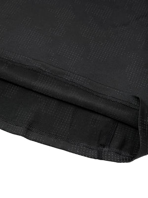 Close-up of the straight bottom hem of the black slim fit mesh shirt with its double stitched edge