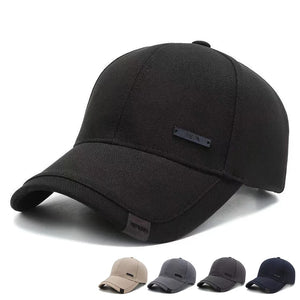 Plain black baseball cap with a small metal tag on the side panel