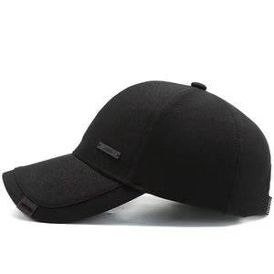 Plain black baseball cap with a small metal tag on the side panel