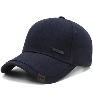 Plain black baseball cap with a small metal tag on the side panel