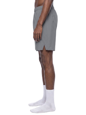 Side view of the Light Gray nylon shorts on a model, perforated side panel and split side hem