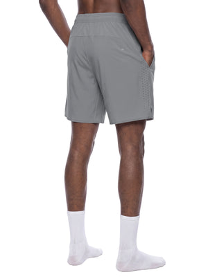 Light Gray athletic shorts in a back three-quarter view on a model, hand in the zip side pocket