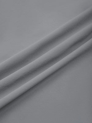Light Gray nylon stretch fabric of the athletic shorts in soft folds, smooth woven surface
