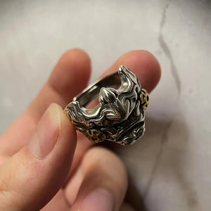 Antiqued metal ring shaped as a horned oni mask with gold accents