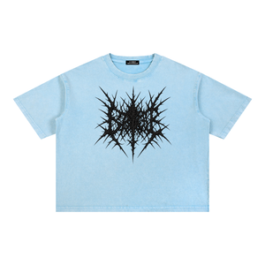 Sky Blue oversized acid wash tee laid flat, front view with the black spiky graphic printed on the chest